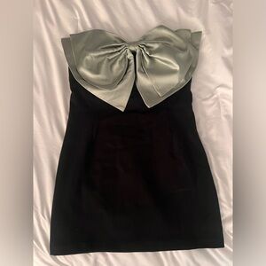 Short black formal dress with green satin bow
